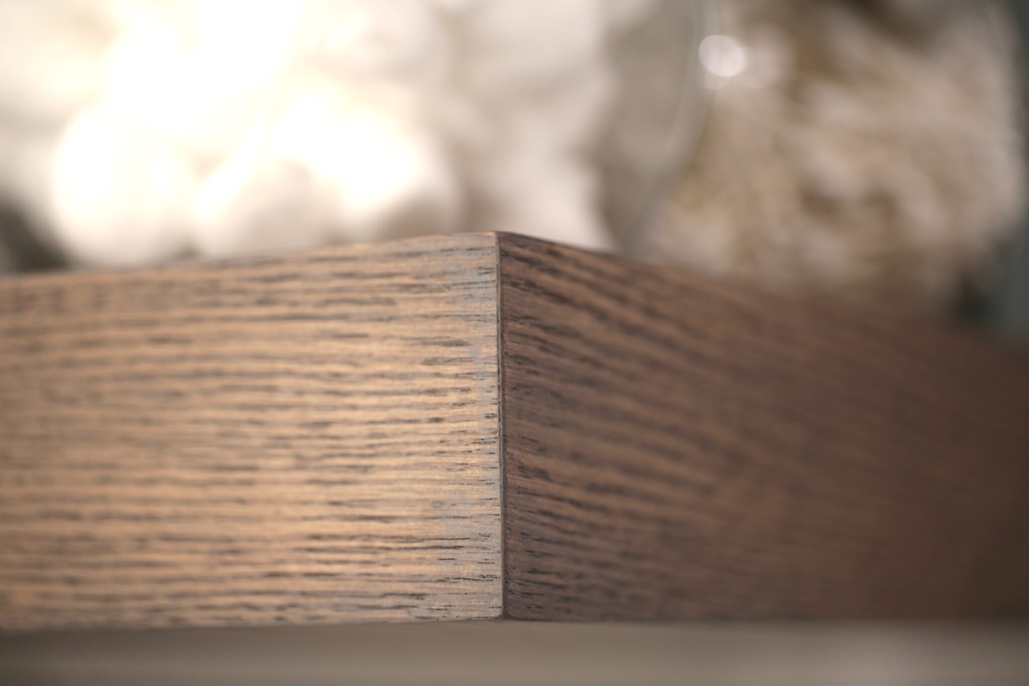 Close-up of corner detail on wood vanity countertop